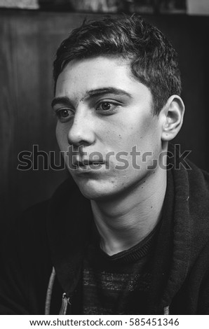 Similar – Boy with a white T-shirt in front of a dark wall