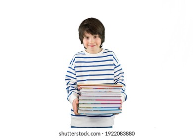 Portrait Of A Young Boy Of Ten Years Old Wearing Striped T Shirt, Holding Large Books In His Hands. Child Smiling At The Camera, Isolated On White Background, Copy Space. 