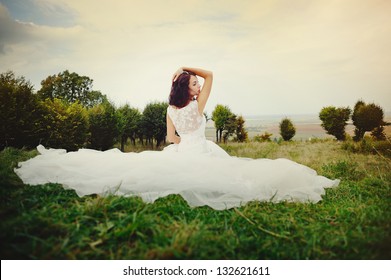 Portrait of Young Bride in garden Wearing Wedding Dress