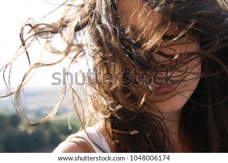 Similar – Image, Stock Photo Young woman at the stand blond hair blows around her