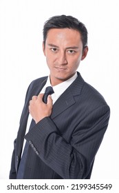 Portrait of young business man in black suit with tie in studio - Shutterstock ID 2199345549