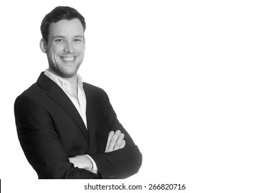 Portrait Of A Young Business Man In Front Of  White Studio Background, Monochrome Photo With Copy Space On The Right Side Of The Image