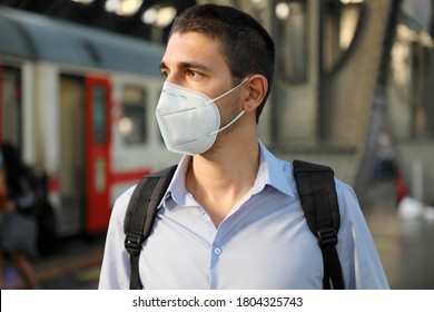 Portrait of young business man waiting train with KN95 FFP2 protective mask at train station - Powered by Shutterstock