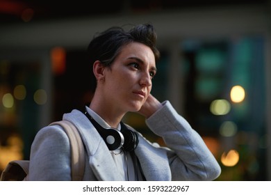 Portrait Young Business Woman In City Wearing Headphones