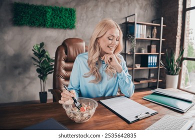 Portrait of young business woman eat lunch read document wear shirt loft interior business center office indoors - Powered by Shutterstock