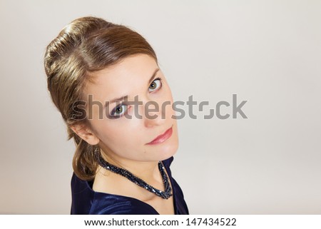 Portrait of young business woman looking up