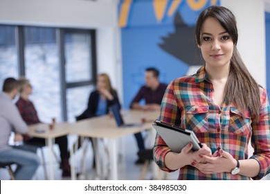 Portrait Of Young Business Woman At Modern Startup Office Interior, Team In Meeting In Background