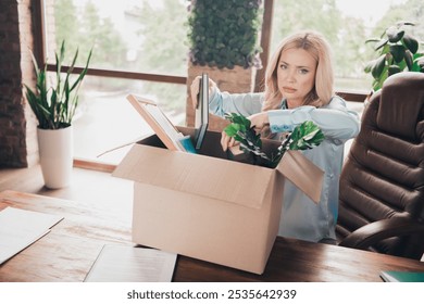 Portrait of young business woman sad sullen face pack belongings box fired loft interior business center office indoors - Powered by Shutterstock