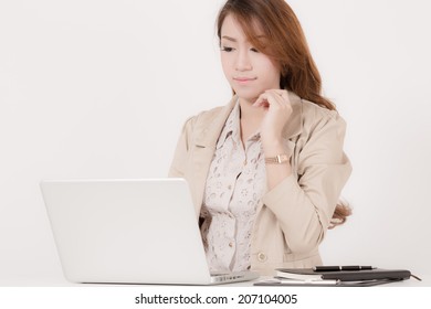Portrait of a young business woman using laptop at office - Shutterstock ID 207104005