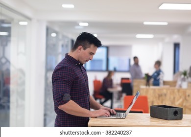 Portrait Of Young Businessman In Casual Clothes At Modern  Startup Business Office Space,  Working On Laptop  Computer