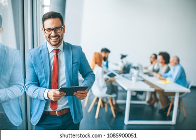 Portrait of young businessman with digital tablet in office - Powered by Shutterstock