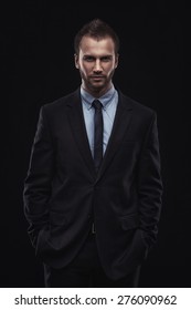 Portrait Of Young Businessman Isolated On Dark Background