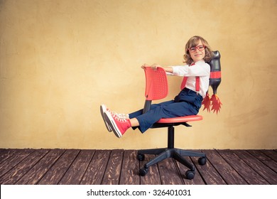 Portrait Of Young Businessman With Jet Pack Riding Office Chair. Success, Creative And Innovation Technology Concept. Copy Space For Your Text