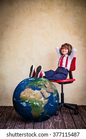 Portrait Of Young Businessman Kid In Office. Global Business Concept. Elements Of This Image Furnished By NASA