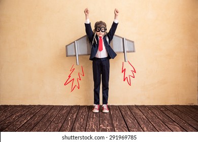 Portrait Of Young Businessman With Toy Paper Wings. Success, Creative And Start Up Concept. Copy Space For Your Text