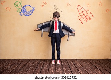 Portrait of young businessman with toy paper wings. Success, creative and start up concept. Copy space for your text