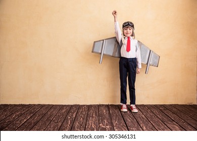 Portrait of young businessman with toy paper wings. Success, creative and start up concept. Copy space for your text - Shutterstock ID 305346131