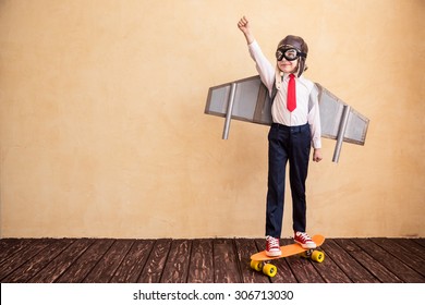 Portrait of young businessman with toy paper wings. Success, creative and start up concept. Copy space for your text - Shutterstock ID 306713030