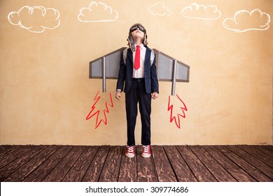 Portrait Of Young Businessman With Toy Paper Wings. Success, Creative And Start Up Concept. Copy Space For Your Text