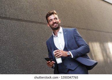 Portrait Of Young Businessman Walking On Street To Office.