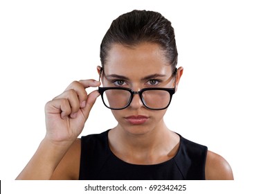 Portrait of young businesswoman holding eyeglasses against white background