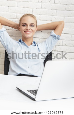 portrait of young businesswoman smiling while sitting relax at office