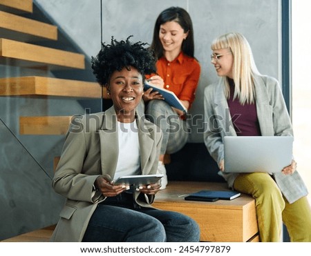 Portrait of young businesswomen having a meeting in the office. Teamwork and success concept, portrait of a smart young businesswoman