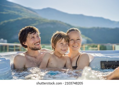 Portrait of young carefree happy smiling happy family relaxing at hot tub during enjoying happy traveling moment vacation. Life against the background of green big mountains - Shutterstock ID 2103748205