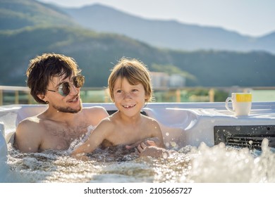 Portrait Of Young Carefree Happy Smiling Happy Family Relaxing At Hot Tub During Enjoying Happy Traveling Moment Vacation. Life Against The Background Of Green Big Mountains