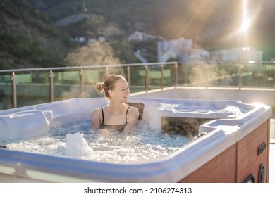 Portrait of young carefree happy smiling woman relaxing at hot tub during enjoying happy traveling moment vacation life against the background of green big mountains - Shutterstock ID 2106274313