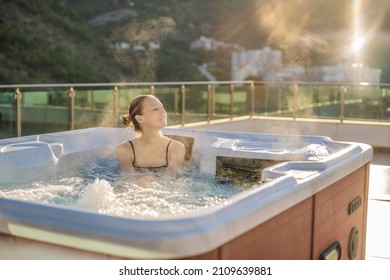 Portrait of young carefree happy smiling woman relaxing at hot tub during enjoying happy traveling moment vacation life against the background of green big mountains - Powered by Shutterstock