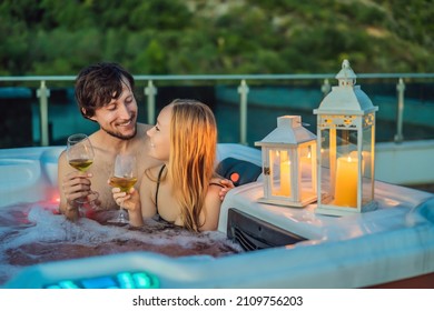 Portrait of young carefree happy smiling couple relaxing at hot tub during enjoying happy traveling moment vacation life against the background of green big mountains