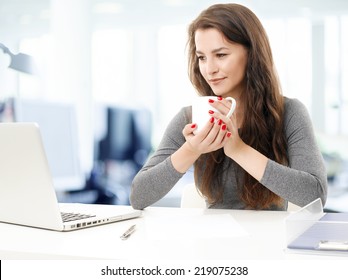 Portrait Of Young Casual Trainee Lawyer Sitting At Office While Working On Laptop. 