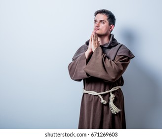 Portrait of Young catholic monk on white background