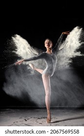 Portrait Of Young Caucasian Elegant Woman In Flour Powder Dancing Gracefully, Isolated On Black Studio Background, Wearing Black Bodysuit. Ballet, Dance, Performance, Art, People Concept