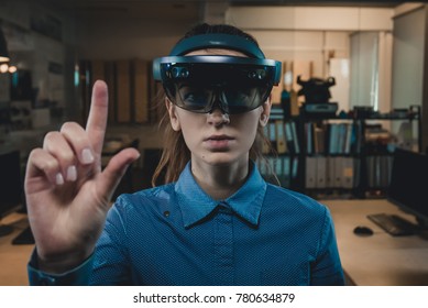 Portrait of young Caucasian female using augmented reality holographic hololens in modern office - Shutterstock ID 780634879