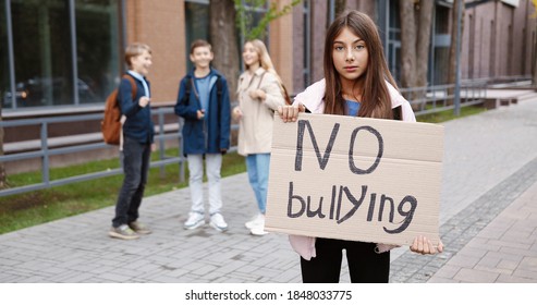 Portrait Of Young Caucasian Schoolgirl Standing Outdoor With 