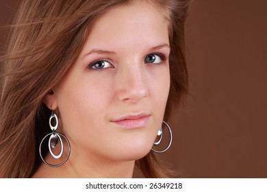 portrait of a young caucasian woman, brown background - Shutterstock ID 26349218
