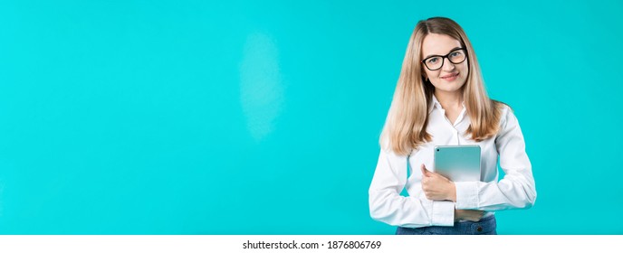 Portrait young caucasian woman worker teacher trainer mentoring in white shirt office style long hair with a tablet in hand uses technology isolated bright color blue background.