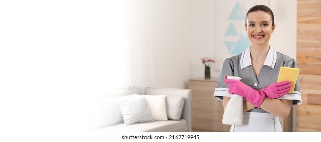 Portrait Of Young Chambermaid With Cleaning Supplies In Hotel Room, Space For Text. Banner Design