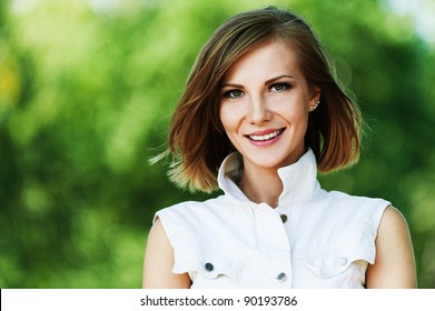 portrait young charming short-haired woman background summer green park