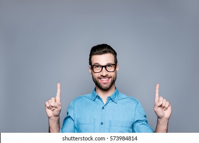 Portrait Of Young Cheerful Bearded Man In Glasses Gesturing Up.