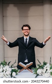 Portrait Of Young Cheerful Caucasian Marriage Officiant During Wedding Ceremony