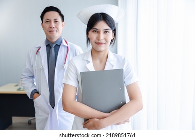 Portrait Of Young Cheerful Smiling Nurse And Doctor At Hospital