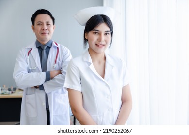 Portrait Of Young Cheerful Smiling Nurse And Doctor At Hospital