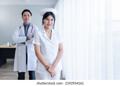 Portrait Of Young Cheerful Smiling Nurse And Doctor At Hospital