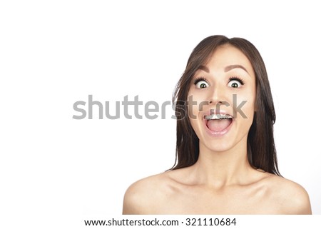 Portrait of young cheerful smiling woman, over grey background