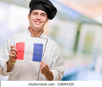 Portrait Of A Young Chef Holding French Flag, Indoor