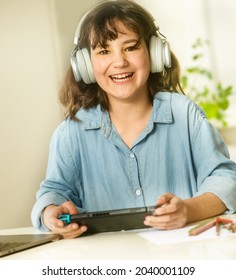 portrait of young child girl doing on-line homework, home schooling, distance learning