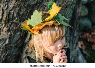 Portrait Of Young Child With Leaf Crown, Autumn Concept